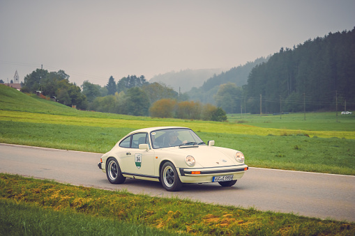 Gessertshausen, Germany - September 25, 2022: 1981 Porsche 911 german oldtimer vintage sports car in a picturesque landscape.