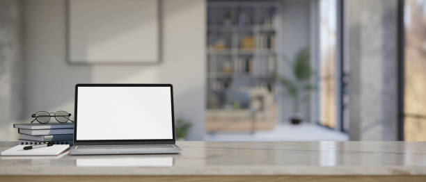 istock Notebook laptop mockup and copy space on modern tabletop over blurred living room background 1430957569