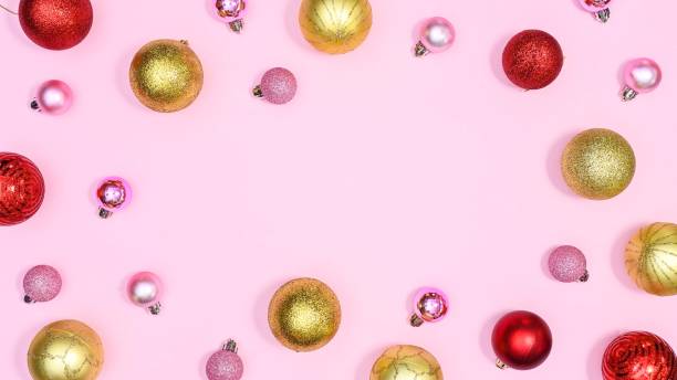 istock Creative Christmas and new year pattern with gold, red and pink ornaments on pink background with copy space. FLat lay 1430957772