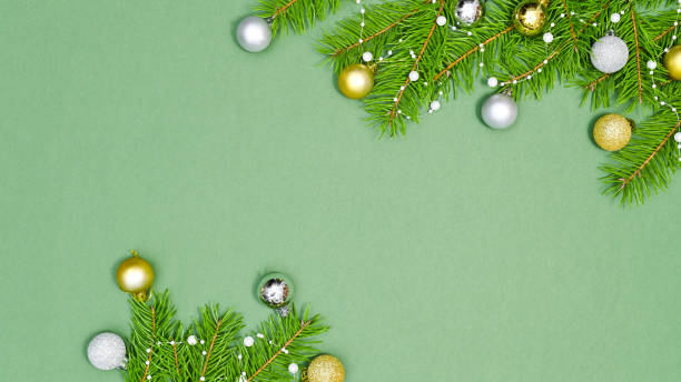 istock Fir branches with golden and silver ornaments on copy space vibran green background. FLat lay 1430958238