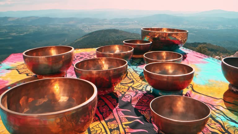 SLO MO DS Metal singing bowls set on the top of the sunny mountain