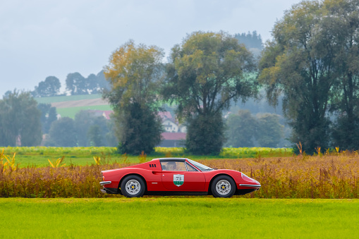 Salgen, Germany - September 25, 2022: 1973 Ferrari Dino 246 GTS italian oldtimer vintage sports car in a picturesque landscape.