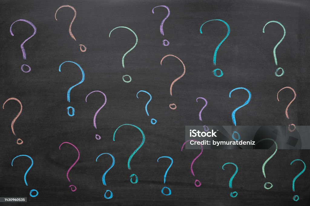 Colorful question marks on blackboard Asking Stock Photo