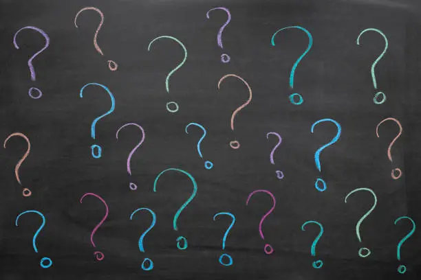 Photo of Colorful question marks on blackboard