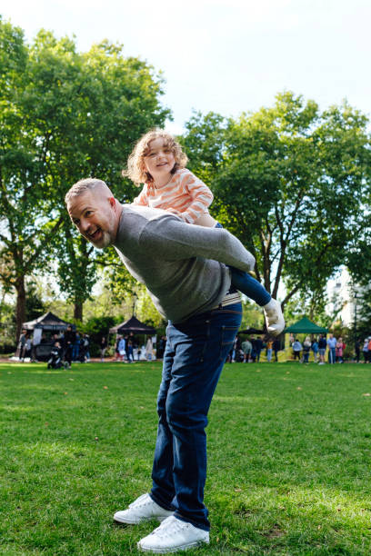 istock Father giving a daughter piggyback ride when playing in the park. 1430961249