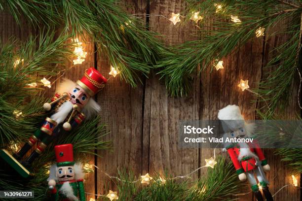 Christmas Composition Of Coniferous Branches Nutcrackers Toys And Lighting Garlands Stock Photo - Download Image Now