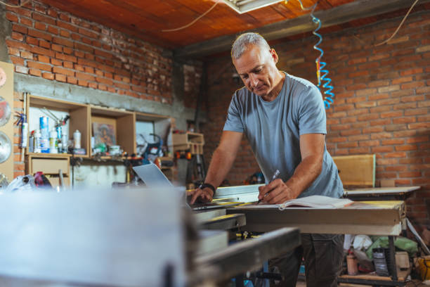 istock Worker at carpenter office writing on paper new order 1430965729