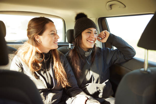 istock Two friends enjoy a road trip in a car interior. 1430966671