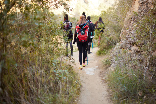istock Backpackers hike next to a ravine on a footpath. 1430966732