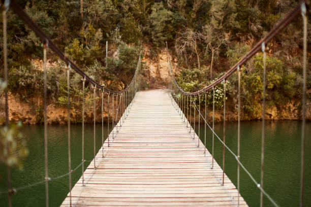 An empty wooden suspension bridge.