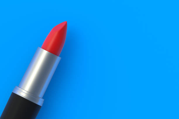 istock One lipstick on blue background. Cosmetic accessories. Make-up tools. Top view. Copy space. 3d render 1430967246