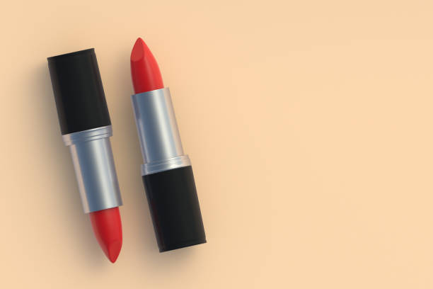 istock Red lipsticks on beige background. Cosmetic accessories. Make-up tools. Copy space. Flat lay. 3d render 1430967253