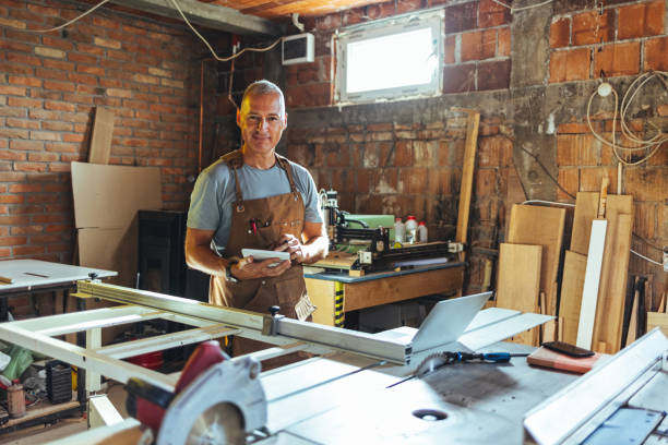 istock Mature male carpenter checking inventory indoors in workshop. 1430967415