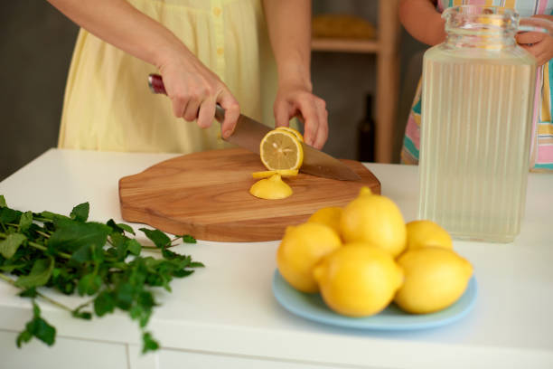 istock Make homemade lemonade with fresh yellow lemons and green mint 1430968954