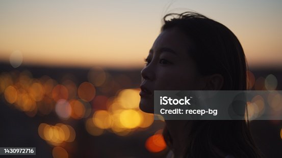 istock Portrait of young woman on top of cliff in nature 1430972716