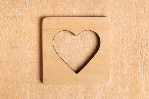 White wooden heart on rustic table with copy space