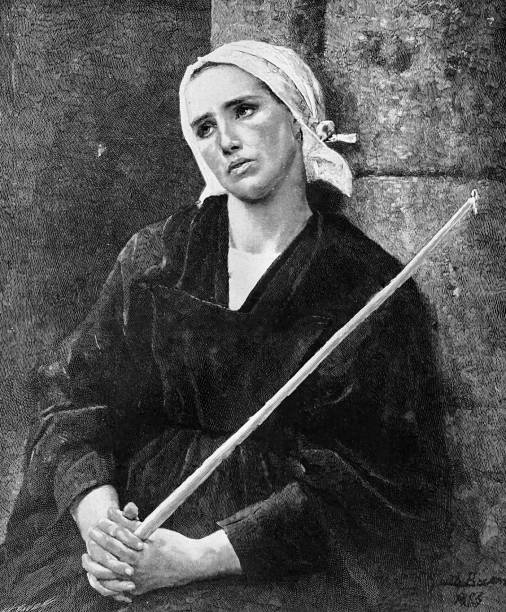 istock Young woman with headscarf sitting praying with hands folded, holding a pole 1430973873