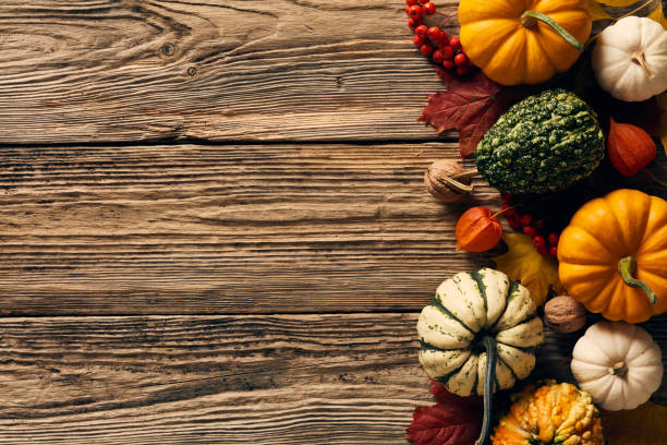 istock Autumn still life with pumpkins, fallen leaves, walnuts, fall decorations on wooden background. Happy Thanksgiving Day concept. Flat lay, top view, copy space. 1430974182