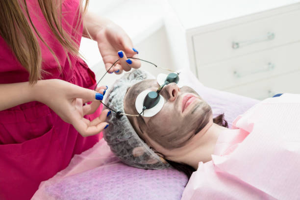 istock A woman is put on protective glasses during the carbon peeling procedure 1430977802