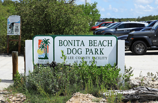 Bonita Beach, Florida, USA - July 23, 2022:  Dog Beach Park entrance sign, a fun park where dogs can run free on a beautiful beach.
