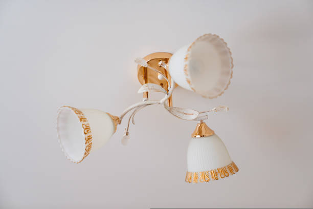istock classic ceiling lamp with white lampshades with gold decor. 1430979144