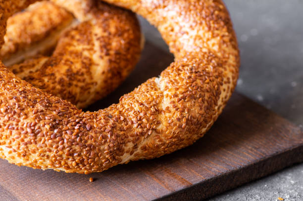 istock Turkish traditional bagel / simit with sesame on rustic table, turkish breakfast pastry concept 1430979717