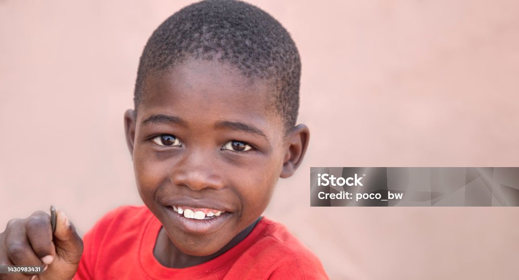 smiley African boy happy African kid in the yard, village in Botswana Child Stock Photo