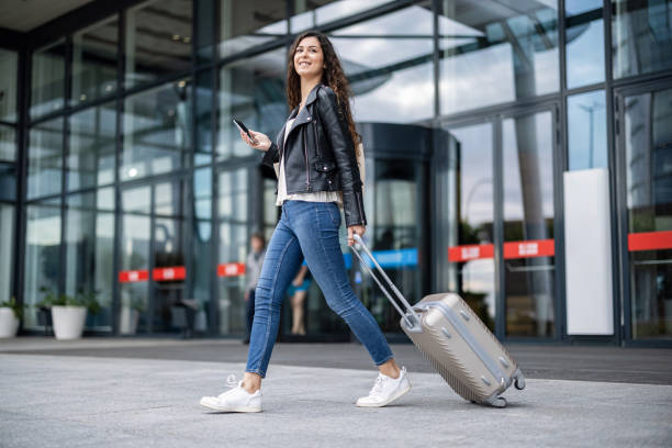istock Beautiful woman rolling suitcase 1430984698