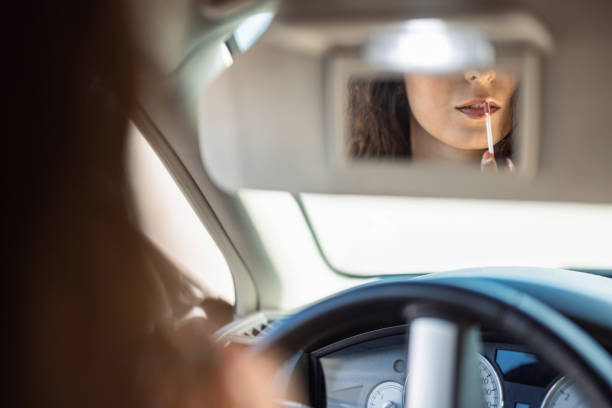 istock Woman fixing her makeup in the car 1430986036