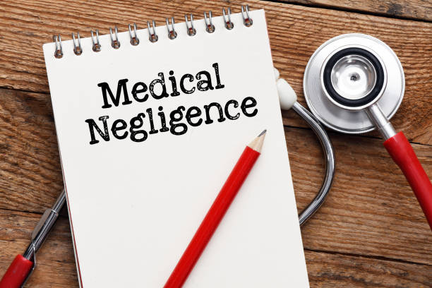 istock Medical negligence words in an office notebook next to a stethoscope. 1430988333