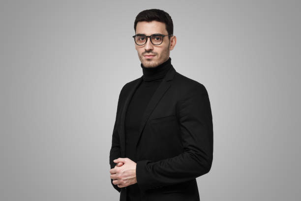 istock Serious reserved guy in black turtleneck, glasses and jacket ready to answer complicated questions 1430989539