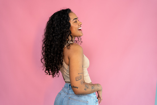 Young woman on a pink background