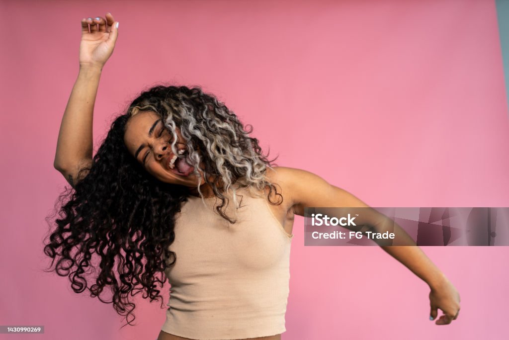 Young woman dancing on a studio shot Young woman dancing Dancing Stock Photo