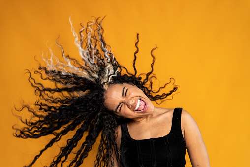 Young woman shaking hair