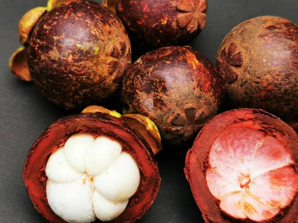 istock fresh mangosteen in a bowl on black background 1430990554