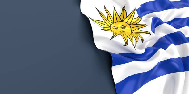 ウルグアイの国旗がブルーグレーの表面に振られている - uruguayan flag ストックフォトと画像