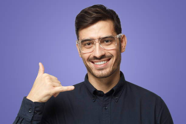 istock Guy isolated on purple background, showing gesture as if asking to dial him, looking confident 1430993702