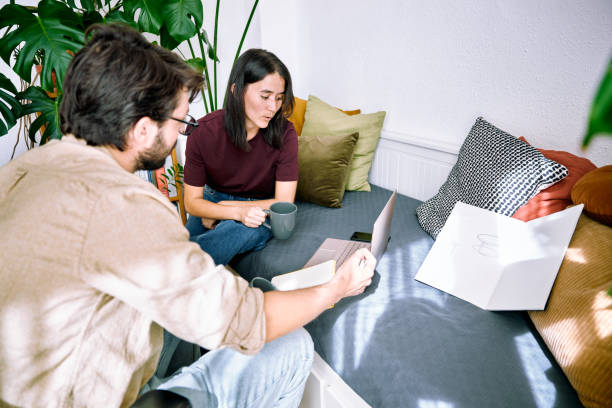 istock A young adult couple working remotely from home. 1430994643
