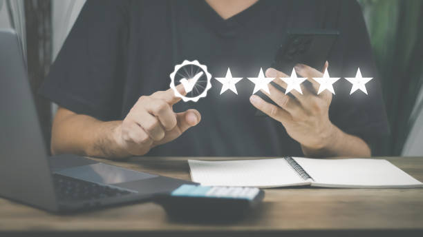 istock Customer Satisfaction Survey Concept, A man's hand using a smartphone gives a 5 star rating to show the highest level of satisfaction with excellent service.. 1430996811