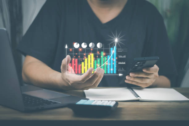 istock financial and investment technology concept,man's hand using computer to analyze graphs and charts of stock market digital assets gold and oil to be in line with the volatility of the world economy 1430996819