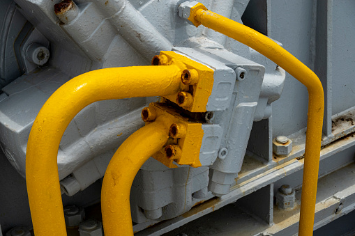Yellow parts of the anchor dropper on the ship