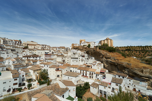 Setenil de las Bodegas is a town in southern Spain. It’s known for its whitewashed houses built into the surrounding cliffs. The town's hilltop castle was once an Arab fortress. Torreón del Homenaje tower offers views of the town and countryside.