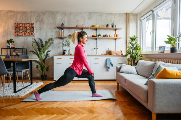 istock Young Woman Stretching Before Exercising At Home 1431001886