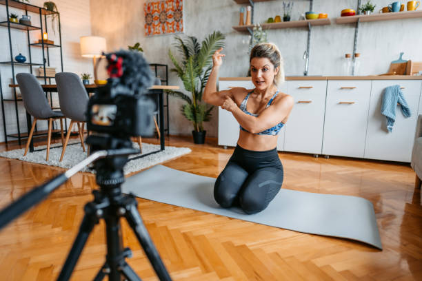 istock Young Woman Filming A Vlog On Exercising At Home 1431002804