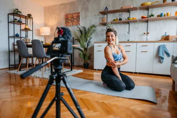 istock Young Woman Filming A Vlog On Exercising At Home 1431002831