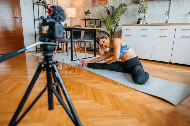 istock Young Woman Filming A Vlog On Exercising At Home 1431002870