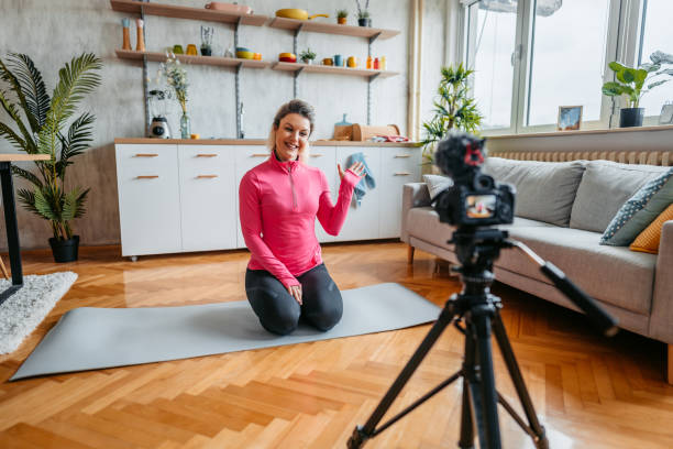 istock Young Woman Filming A Vlog On Exercising At Home 1431003500