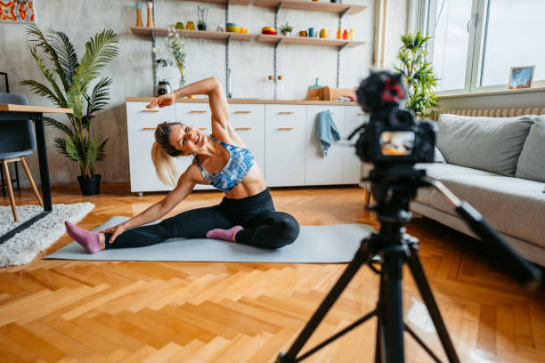 istock Young Woman Filming A Vlog On Exercising At Home 1431003516