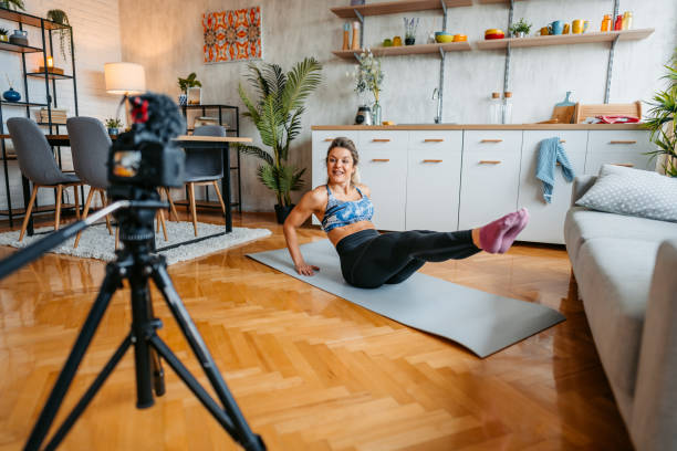 istock Young Woman Filming A Vlog On Exercising At Home 1431004097