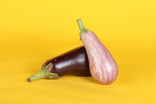 eggplants isolated on yellow background
